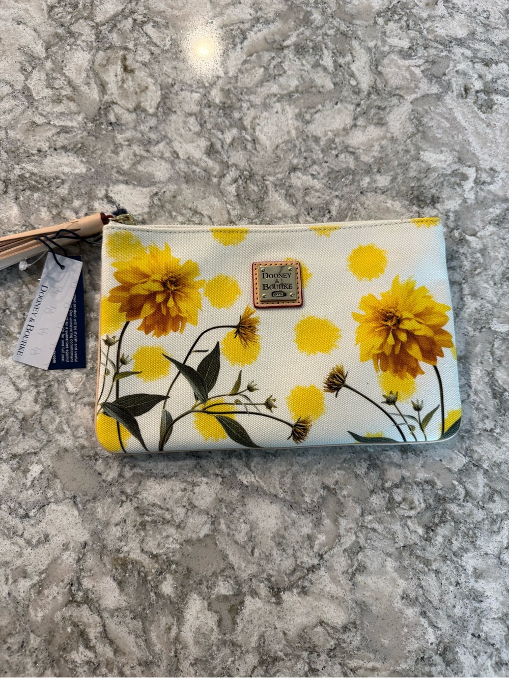 NWT Dooney & Bourke floral printed canvas clutch with a leather tassel accent